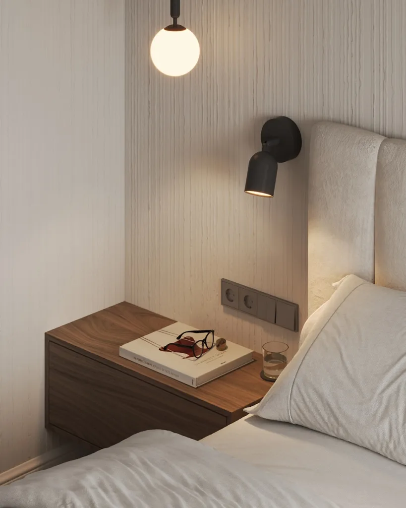 A bed with a white comforter and a night stand